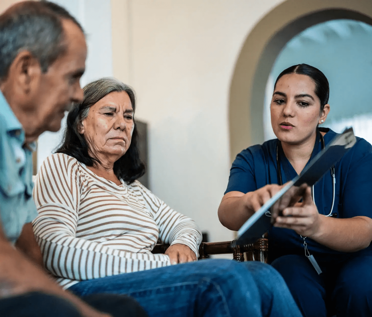 Nurse explaining document to elderly couple
